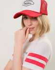 Side-view of a model wearing a red and white 'Welcome To The Fearless Speakeasy' trucker hat and and and "I I II I" Athletic t-shirt with a visible black Birdiebee logo on a plain white background