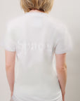 Back-view of a model wearing a printed, tonal white pocket t-shirt with 'Space." written on across the back center and Birdiebee stone sweatpants on a plain background