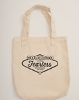 Beige canvas tote bag with 'Welcome to the Fearless Speakeasy' black printed graphic art featuring the BB logo on an off-white background