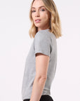 Model wearing a gray t-shirt on a white background