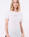 Model wearing a white t-shirt with 'LEGEND' printed in black on the center of the chest in front of a white background
